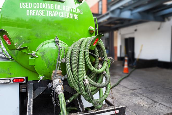 technicians pumping out a commercial grease trap in Brisbane